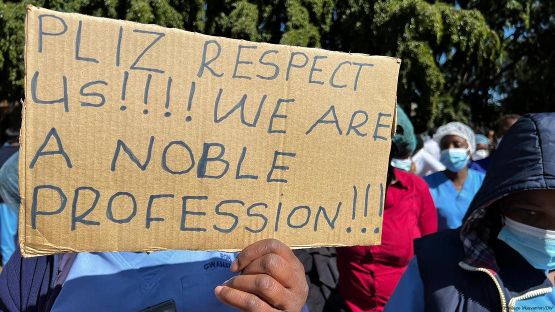 A man holds a sign asking for respect for the healthcare profession at a demonstration in 2021. 