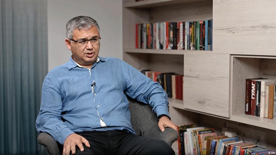 Abbas Gallyamov bir kitaplığın yanında koltukta oturuyor