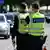 German federal police officers watch vehicles and traffic coming into Germany from Poland at a border control station on a bridge between the two countries in Guben, eastern Germany, on May 9, 2025