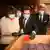 People wearing gloves and masks look at materials found in Supreme Court archives in Buenos Aires, Argentina