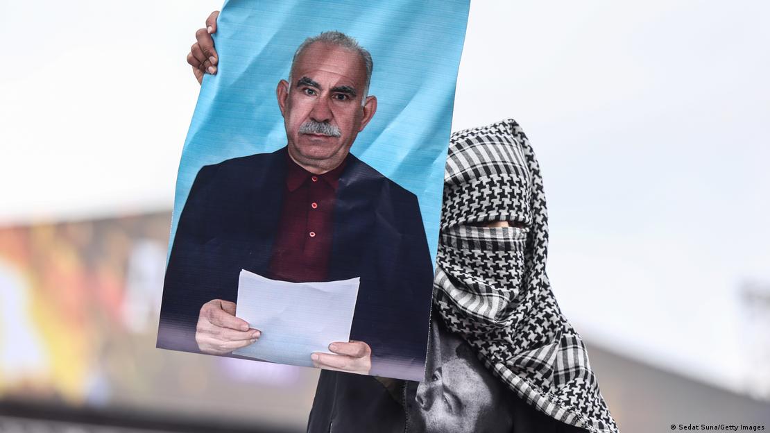 Diyarbakır'da geçen yıl düzenlenen Nevruz kutlamasında yüzünü kapamış bir eylemci Öcalan'ın fotoğrafını taşıyor Diyarbakır'da geçen yıl düzenlenen Nevruz kutlamasında yüzünü kapamış bir eylemci Öcalan'ın fotoğrafını taşıyor