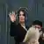 US celebrity Kim Kardashian (C) waves as she arrives at the Assize Court in Paris on April 28, 2025