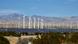 Solar panels and wind turbines in North Palm Springs, mountains are seen in the background Solar panels and wind turbines in North Palm Springs, mountains are seen in the background