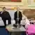 President Maduro and first lady Cilia Flores (left) sit on a sofa while two women seated on another smile and watch a curly-haired child (Maikelys Espinoza) play on May 14, 2025
