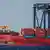 A container ship is docked at a cargo terminal in Tokyo