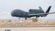 A Global Hawk UAV drone aircraft landing on a runway A Global Hawk UAV drone aircraft landing on a runway