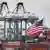 Chinese shipping containers are stored beside a US flag after they were unloaded at the Port of Los Angeles in Long Beach, California, on May 14, 2019