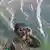 An Indian army soldier keeps a vigil from one of the forward post along the line of control between India and Pakistan during a media tour somewhere in north of Indian-controlled Kashmir, Monday, May 19, 2025