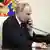 Russian President Vladimir Putin speaks on the phone