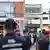 Thai forensic police officers (C) inspect the site of a deadly attack outside the district office of Sungai Kolok in the southern Thailand province of Narathiwat (March 9, 2025)
