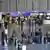 People with their luggage at Frankfurt Airport

