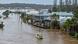 Rescue personnel patrol in flooded waters at homes in Port Macquarie, north of Sydney, Australia Rescue personnel patrol in flooded waters at homes in Port Macquarie, north of Sydney, Australia