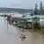 Rescue personnel patrol in flooded waters at homes in Port Macquarie, north of Sydney, Australia