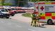 An emergency worker wheels a stretcher past a line of parked ambulances An emergency worker wheels a stretcher past a line of parked ambulances
