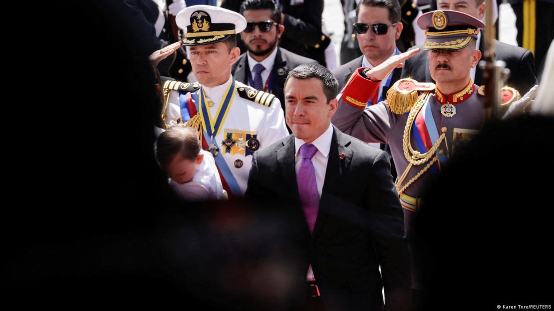 Ecuador's president Daniel Noboa, wearing a suit and purple tie, is pictured ahead of military personnel in ceremonial dress Ecuador's president Daniel Noboa, wearing a suit and purple tie, is pictured ahead of military personnel in ceremonial dress