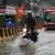 Traffic moving through a waterlogged road in Mumbai