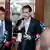 Former Austrian Chancellor Sebastian Kurz talks to reporters holding microphones