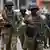 Armed Ugandan soldiers in street in Kampala