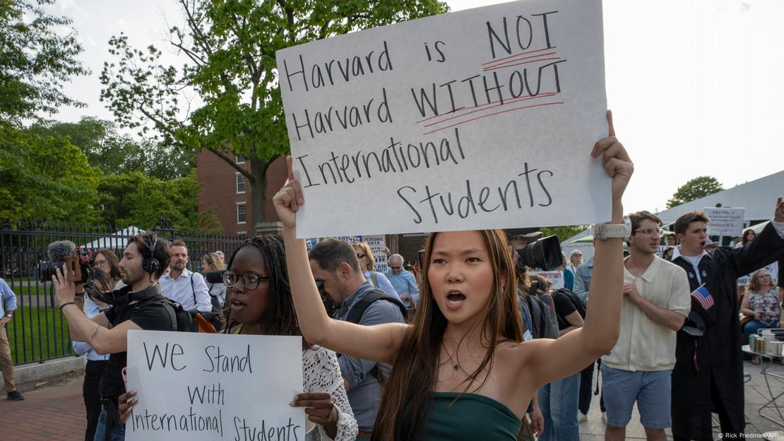 mujer sostiene pancarta a favor de estudiantes extranjeros en la Universidad de Harvard, en medio de manifestación. mujer sostiene pancarta a favor de estudiantes extranjeros en la Universidad de Harvard, en medio de manifestación.
