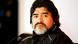 Portrait of a bearded man (Diego Maradona) wearing a black training jacket and headphones seated at a microphone Portrait of a bearded man (Diego Maradona) wearing a black training jacket and headphones seated at a microphone