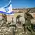 Israeli soldiers guard Jewish settlers as they seize the lands of Palestinian farmers in the village of Burqin, west of Salfit, in the occupied West Bank