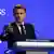 French President Emmanuel Macron gestures as he speaks from a podium at the Shangri-La Dialogue defense summit in Singapore