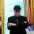 Elon Musk, man with DOGE cap standing in Oval Office with arms folded, on May 30, 2025