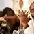 Ugandan rights activist Agather Atuhaire puts her head in her hands as Kenyan rights activist Boniface Mwangi addresses the press with tears in his eyes