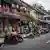Luang Prabang's central Sisavongvang Road with restaurants and foreign tourists visible