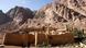 Saint Catherine's Monastery sits enclosed between large stone walls at the base of the Mount Sinai. Saint Catherine's Monastery sits enclosed between large stone walls at the base of the Mount Sinai.