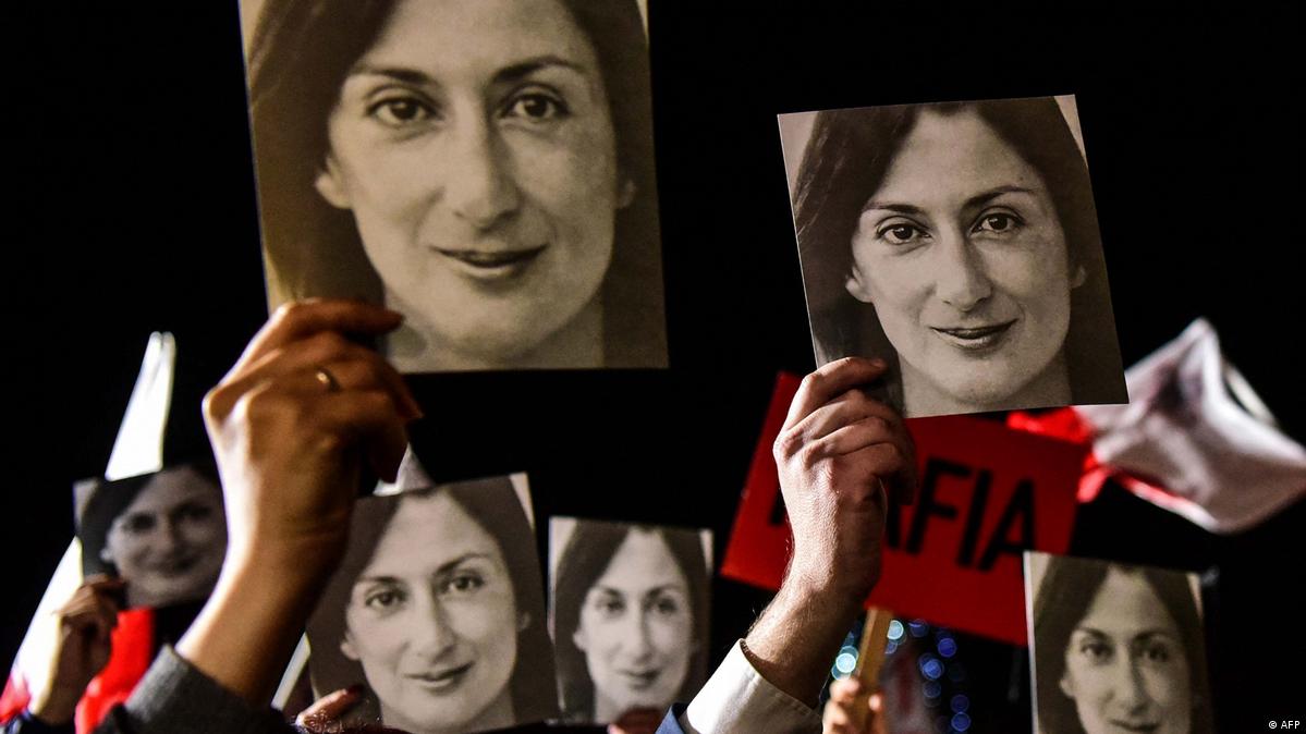 People holding photos of killed journalist Daphne Caruana Galizia at a protest in 2019