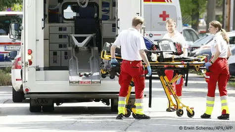 Equipos de rescate con camillas bajan de una ambulancia en las cercanías de la escuela donde se produjo un ataque con varios muertos y heridos en Graz, Austria. Otras ambulancias están estacionadas allí.