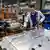 A Volkswagen worker at a car factory making electric vehicles