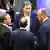 Boris Pistorius, Lars Klingbeil and Friedrich Merz speak among one another in the Bundestag