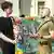 War veteran and open gay Viktor Pylypenko speaks to a young man in a black t-shirt
