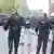A protester stands in front of riot police in Portadown town center, Ballymena.