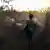 A herder leads animals to feed in the bushes in Benue state, Nigeria on January 4, 2018