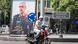A man rides his motorbike past a portrait of slain Iranian armed forces chief of staff in Tehran A man rides his motorbike past a portrait of slain Iranian armed forces chief of staff in Tehran