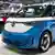 A blue and white Volkwagen electric vehicle at the New York International Auto Show at the Jacob Javits Convention Center.