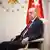 Cumhurbaşkanı Recep Tayyip Erdoğan koltukta otururken