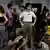 People stand and sit in a bomb shelter in Tel Aviv, June 18, 2025.