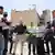 Israeli PM Netanyahu among a group of reporters standing in front of a bombed-out hospital complex