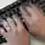 Blurred hands type on a computer keyboard