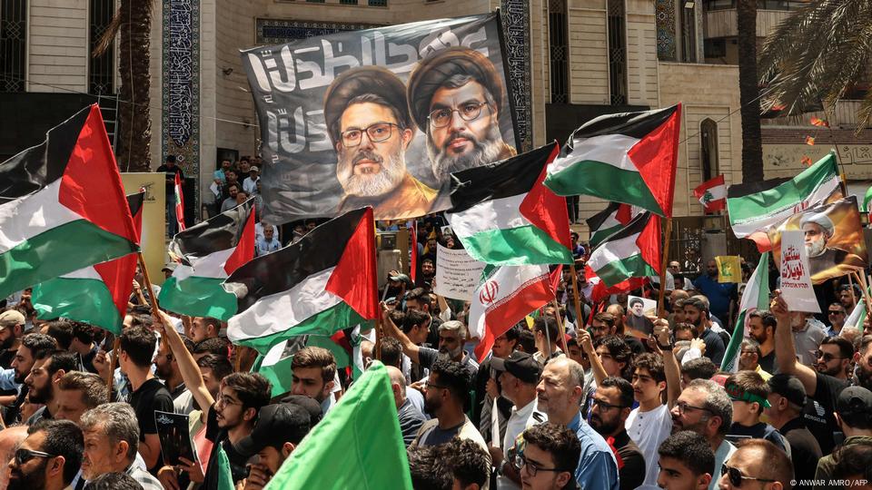 Lebanese Hezbollah supporters wave Palestinian and Iranian flags Lebanese Hezbollah supporters wave Palestinian and Iranian flags