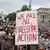A protester holds a placard in support of activist group Palestine Action, which may potentially be banned in the UK, during a march in support of Palestine and in protest against bombing Iran