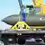In this photo released by the US Air Force on May 2, 2023, airmen look at a GBU-57, or the Massive Ordnance Penetrator bomb, at Whiteman Air Base in Missouri.