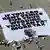 A large banner against Amazon founder Jeff Bezos lies on the ground, placed by Greenpeace Italy activists and UK activist group Everyone Hates Elon, in St. Mark's Square