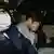 This file photo taken on November 1, 2017 shows suspect Takahiro Shiraishi (C) covering his face with his hands as he is transported to the prosecutor's office from a police station in Tokyo. 