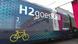 On the side of a train, a sign read: H2 roes Rail On the side of a train, a sign read: H2 roes Rail