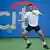 Noah Rubin hitting a ball during a professional tennis match
